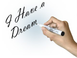 En hand skriver "I have a dream"